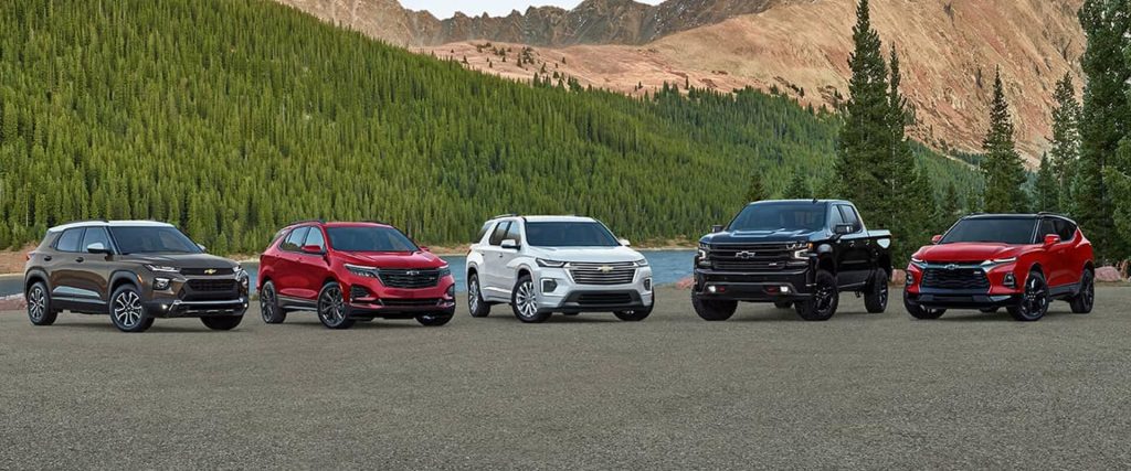 Chevrolet vehicle lineup featuring SUVs, trucks, and crossovers in a mountain landscape