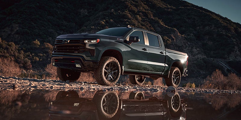 A 2025 Chevy Silverado 1500 driving in a park near Amsterdam, NY