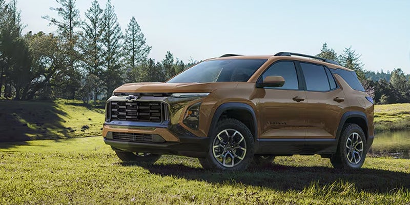 2026 Chevrolet Traverse SUV parked on a grassy outdoor landscape.